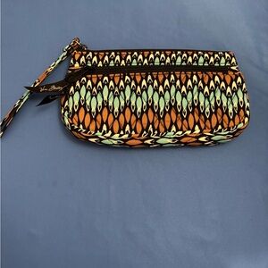 Vera Bradley wristlet wallet with front zipper and card slots inside.